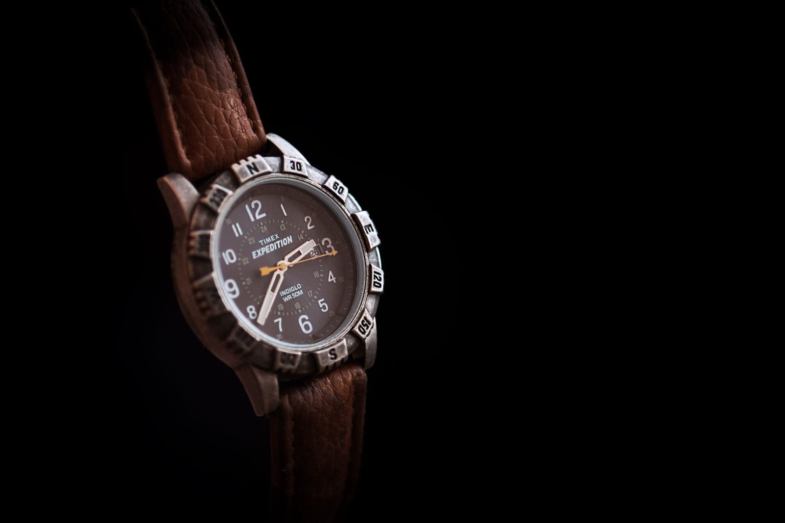 A wristwatch on a brown leather strap, shot close up